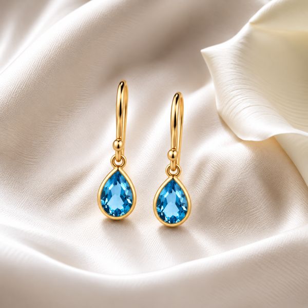 Gouden oorhangers met druppelvormige facet geslepen edelstenen - 14 karaat - 7 x 5 mm · Blauwe Topaas · productfoto · steen:blauwe-topaas