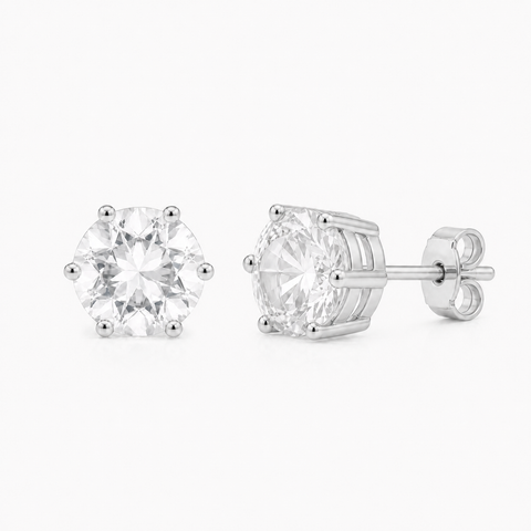 Zilveren oorknopjes met rond gefacetteerde in klauw gezette edelsteen - 925 zilver - 7 mm · Bergkristal