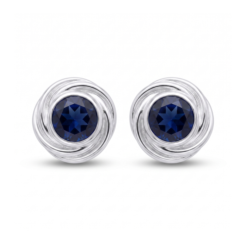 Zilveren oorknopjes met spiraalvormig gezette rond gefacetteerde edelstenen · Onyx · studiofoto · steen:onyx